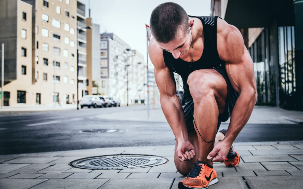 Positive Habits for Happiness
man trying to tie his shoes to Engage in Regular Exercise