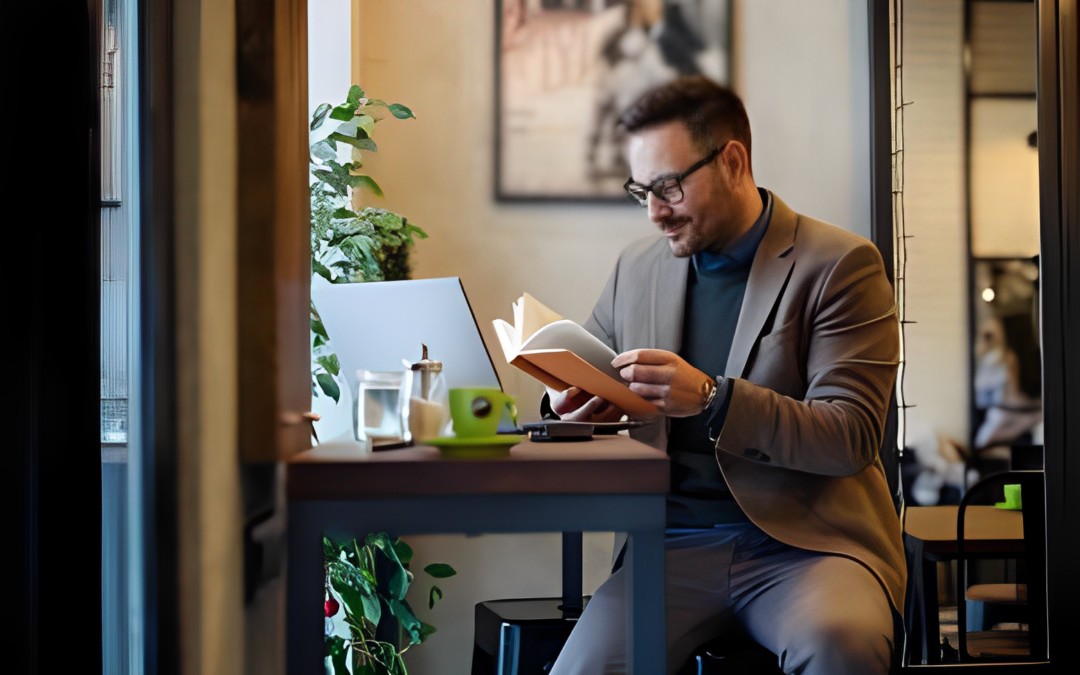 businessman-reading-book-while-sitting-cafe-